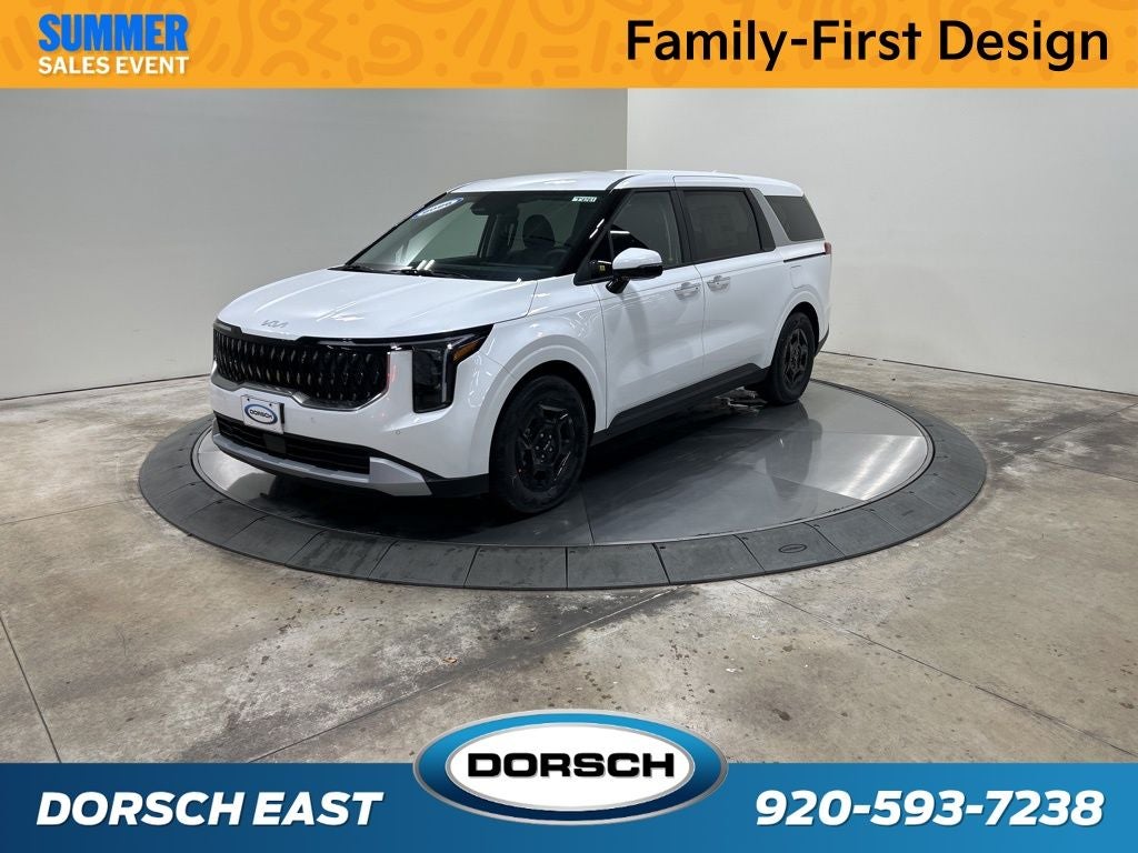 2026 Kia Carnival LXS in Snow White Pearl — front three-quarter view